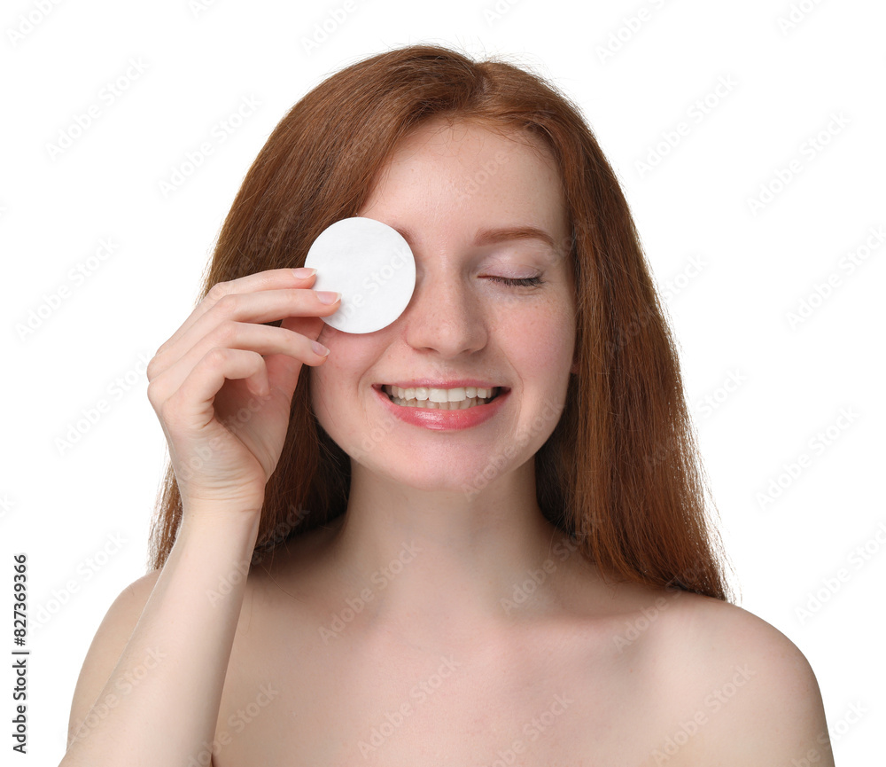 Smiling woman with freckles covering eye with cotton pad on white background Smiling woman with freckles covering eye with cotton pad on white background