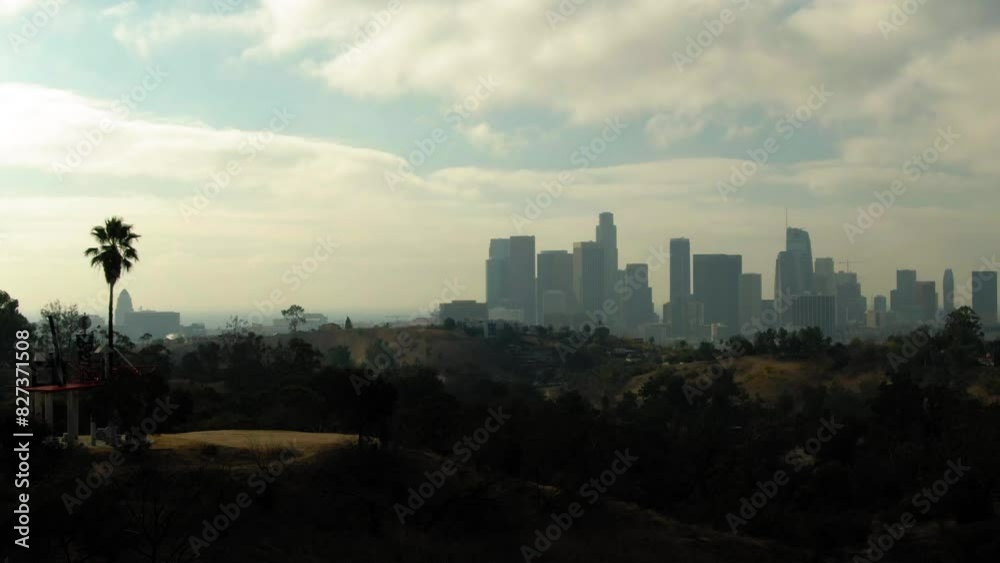 Aerial Panning Shot Of Tranquil Hills By Modern Office Buildings In City Under Cloudy Sky - Los Angeles, California Aerial Panning Shot Of Tranquil Hills By Modern Office Buildings In City Under Cloudy Sky - Los Angeles, California