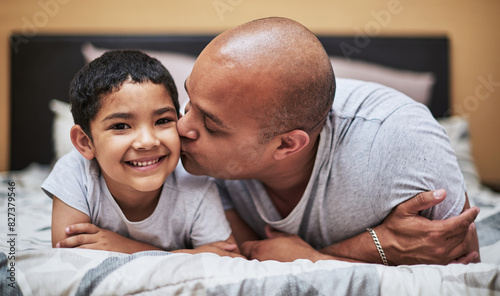 Father, son and kiss on cheek with love in bedroom for bonding with smile, home and family for development. Caring, parent and trust with role model in house for nurturing with positive reinforcement