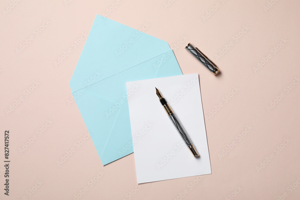 Blank sheet of paper, letter envelope and pen on beige background, top view Blank sheet of paper, letter envelope and pen on beige background, top view