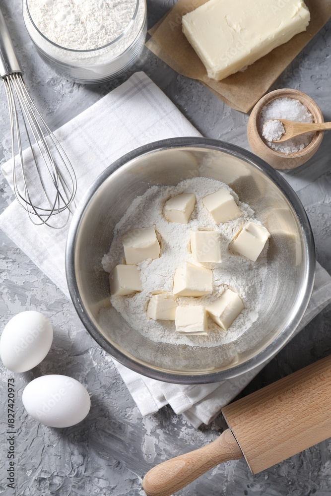 Making shortcrust pastry. Whisk, rolling pin and different ingredients for dough on grey table, flat lay Making shortcrust pastry. Whisk, rolling pin and different ingredients for dough on grey table, flat lay