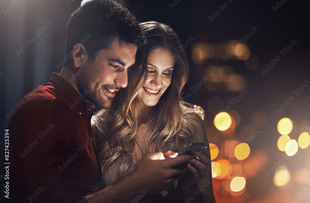 Smartphone, social media and couple on date in city for internet video, funny meme or post. Bokeh, night and romantic man with woman with smile for love, happiness or bonding together in urban town