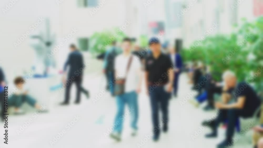 Silhouettes of busy business people walking down the street during the day. Blurred defocused video on business topics. Slow motion. Silhouettes of busy business people walking down the street during the day. Blurred defocused video on business topics. Slow motion.
