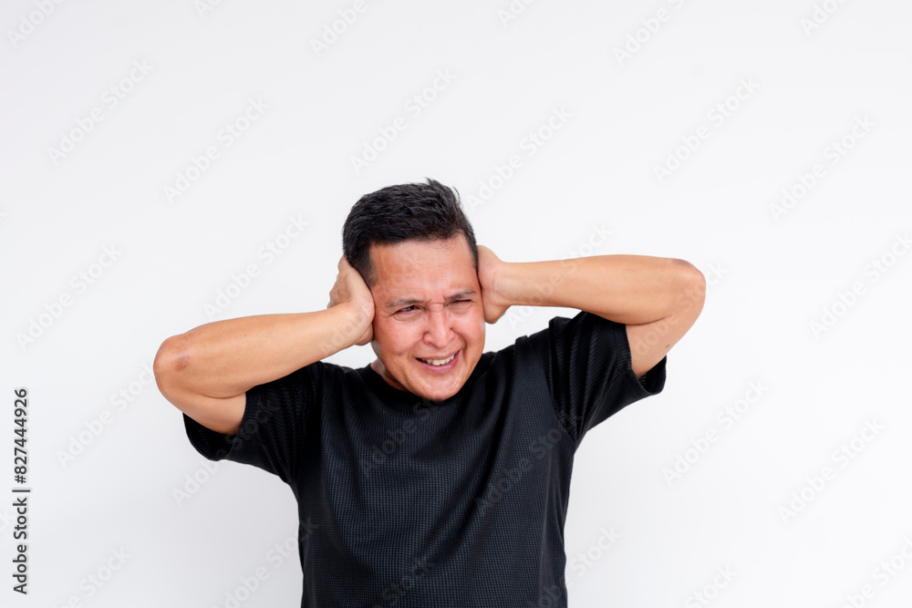 An asian man with oversensitive ears covering from deafening and painful loud noise. An asian man with oversensitive ears covering from deafening and painful loud noise.