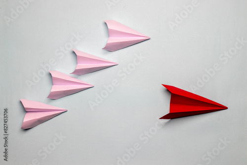 Business concept red plane with white paper planes on a light grey background motivation aviation concept
