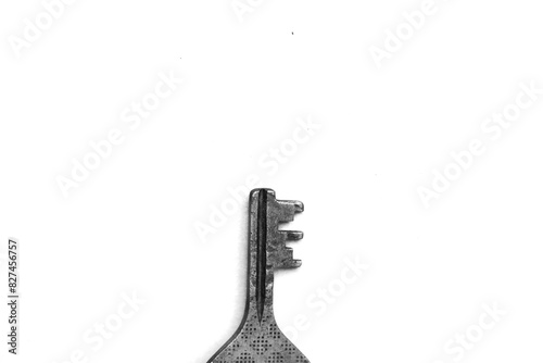 A metal key on a white background black and white photo motivation 