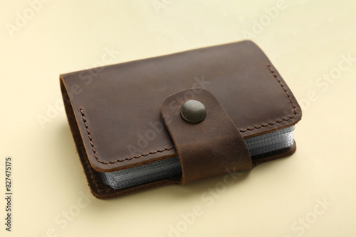 One leather card holder on beige background