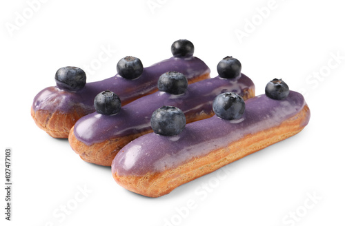 Delicious eclairs decorated with blueberries isolated on white