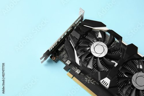 Computer graphics card on light blue background, above view. Space for text
