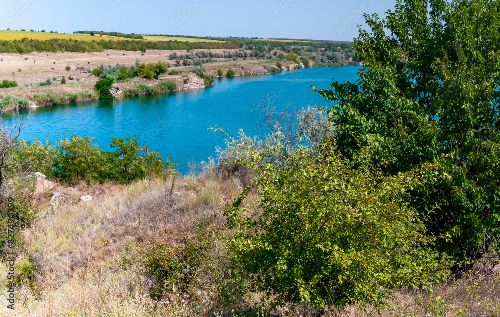 View of the flooded granite quarry with turquoise clear water, Ukraine View of the flooded granite quarry with turquoise clear water, Ukraine