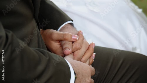 Close-up of the hands of unidentified newlyweds without rings are holding each other 60fps