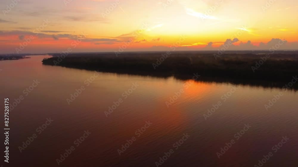 Aerial Tilt Up Backward Beautiful Shot Of Rippled Bayou Under Orange Cloudy Sky At Sunset - Bayou Vista, Texas Aerial Tilt Up Backward Beautiful Shot Of Rippled Bayou Under Orange Cloudy Sky At Sunset - Bayou Vista, Texas