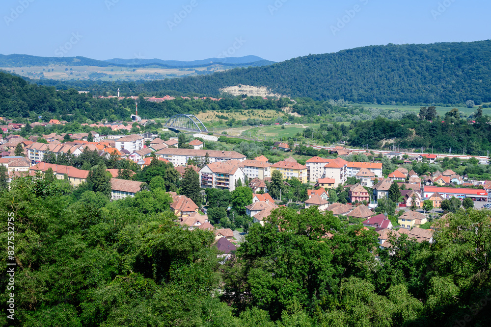 Landscape with view over houses of Sighisoara city, in Transylvania (Transilvania) region of Romania, in a sunny summer day.