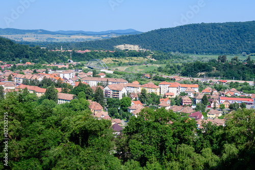Landscape with view over houses of Sighisoara city, in Transylvania (Transilvania) region of Romania, in a sunny summer day. photo