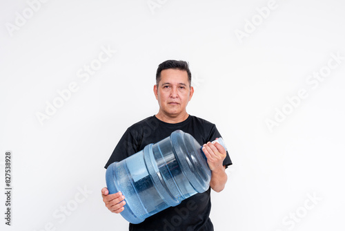 A pensive middle aged man holding a 5 gallon bottle of mineral water. Isolated on a white backgroud. photo