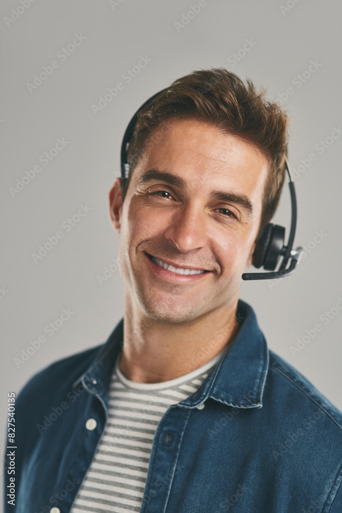 Man, portrait and headset for call centre communication on grey background, contact us or customer support. Male person, face and studio for telemarketing sales or technical advice, crm or helping Man, portrait and headset for call centre communication on grey background, contact us or customer support. Male person, face and studio for telemarketing sales or technical advice, crm or helping