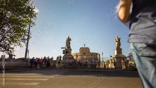 Zoom on Castel Sant'Angelo monument among the most visited in the world in central Europe. Road with traffic of Roman cars and pedestrians and tourists on the streets  photo
