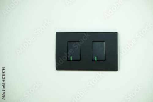 Black light switch on white background. Modern minimalism in the interior.