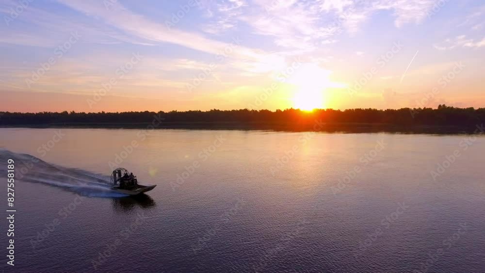 Aerial: Men In Airboat Moving On Rippled River Stream, Drone Flying Backwards During Tranquil Sunset - Bayou Vista, Texas Aerial: Men In Airboat Moving On Rippled River Stream, Drone Flying Backwards During Tranquil Sunset - Bayou Vista, Texas