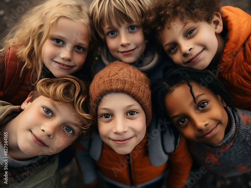 Outdoors, kids gaze down at the camera in unison