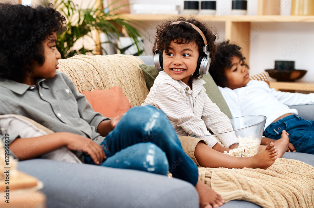 Headphones, child and family on couch for streaming, music and ebook for education or listening on couch. Boy, brothers and online for movies, streaming and relax on sofa with popcorn in home Headphones, child and family on couch for streaming, music and ebook for education or listening on couch. Boy, brothers and online for movies, streaming and relax on sofa with popcorn in home