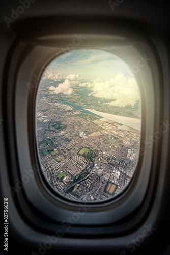 the serene beauty from an airplane window, featuring the wing silhouetted against an expansive, cloud-filled sky, instilling a sense of height and peacefulness.