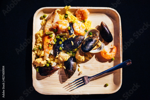 Closeup of a plate of lowcountry boil including mussels and shrimp on a wooden plate with a fork, Savannah, Georgia photo
