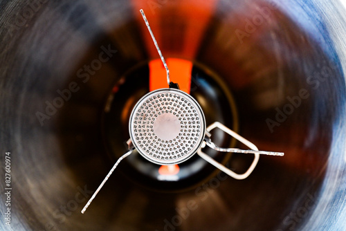 Closeup overhead shot of a camp stove on an isobutane canister, shallow focus photo