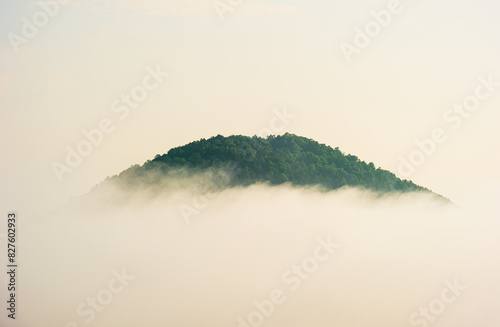 A mountainside peeking through morning fog near Helen, Georgia photo