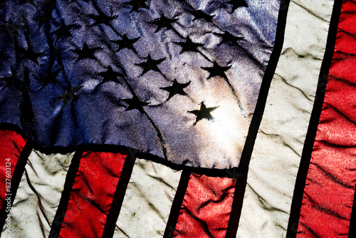 Light from a partial solar eclipse shining through a synthetic American flag, detail photo