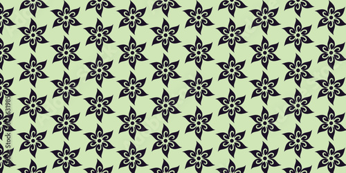 Black floral motif pattern on a light green background
