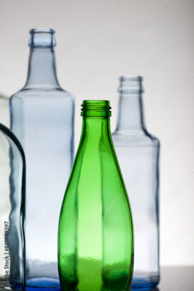 Empty glass water bottles on a table Empty glass water bottles on a table