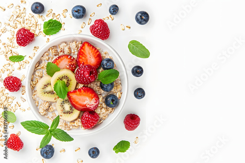 Healthy oatmeal served with berries and fresh fruits on white background. Healthy breakfast. Top view