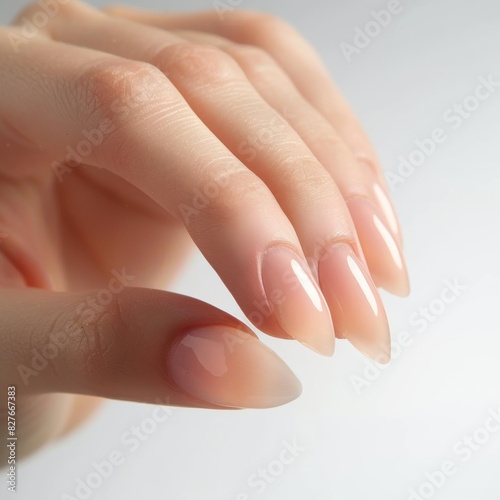Close-up of well-manicured hands with long  elegant nails against a clean  white background  showcasing natural beauty and nail care.