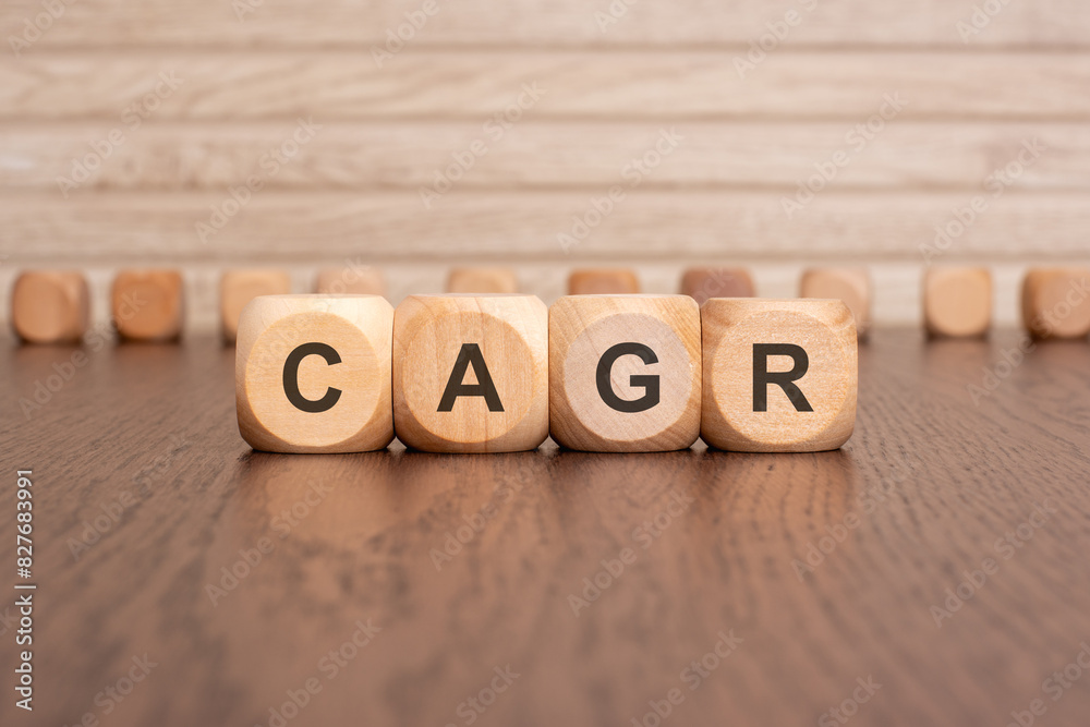 the text CAGR is written on wooden cubes on a brown background the text CAGR is written on wooden cubes on a brown background