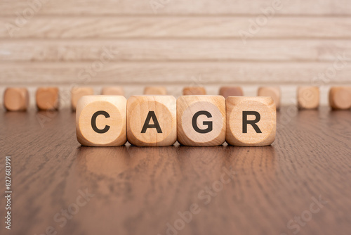 the text CAGR is written on wooden cubes on a brown background