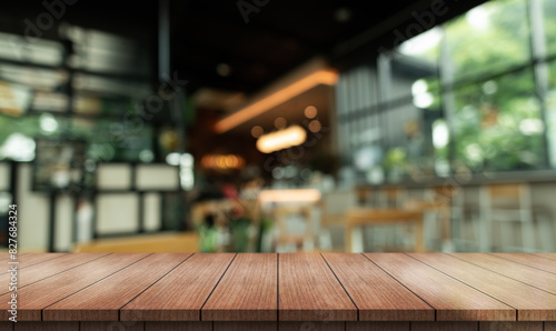 Empty wooden table to p with lights bokeh on blur restaurant background.