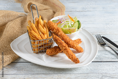 Fish and Chips is a classic British dish featuring battered and deep-fried fish, usually cod or haddock, served with crispy potato fries