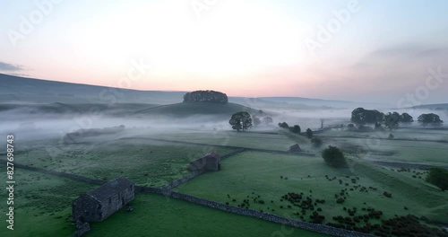Flying over English countryside on a misty morning