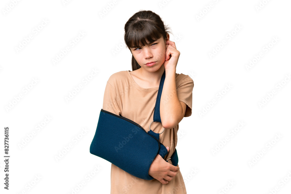 Little caucasian girl with broken arm and wearing a sling over isolated background frustrated and covering ears Little caucasian girl with broken arm and wearing a sling over isolated background frustrated and covering ears