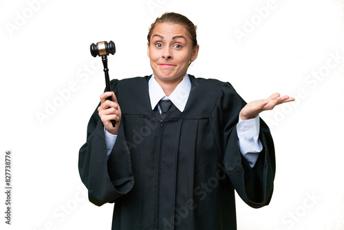 Judge caucasian woman over isolated background having doubts while raising hands photo