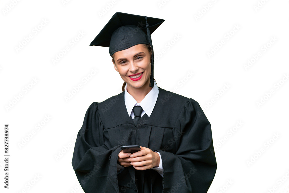 Young university graduate caucasian woman over isolated background sending a message with the mobile Young university graduate caucasian woman over isolated background sending a message with the mobile