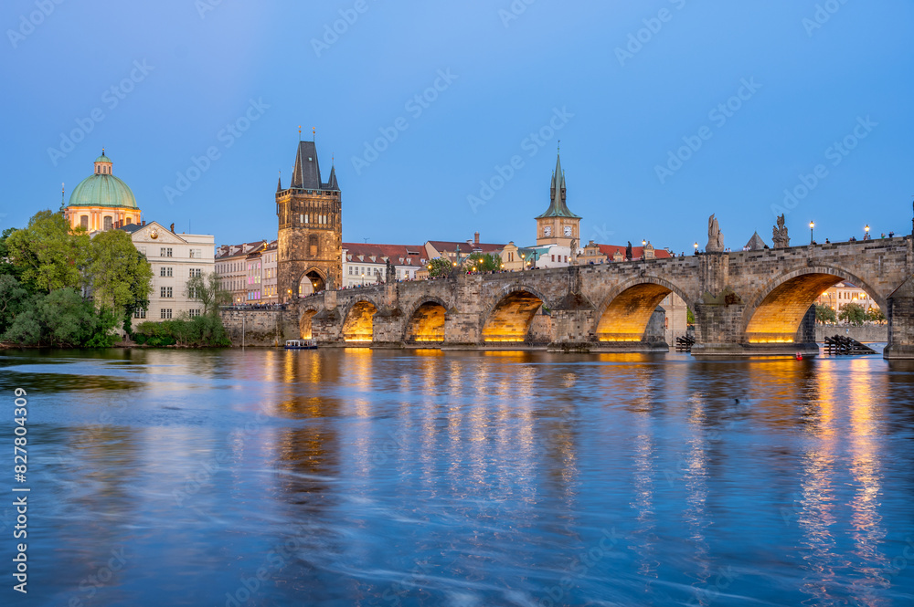 Charles Bridge (Karlův most) over Vltava river, illuminated in the evening, Prague, Czech Republic