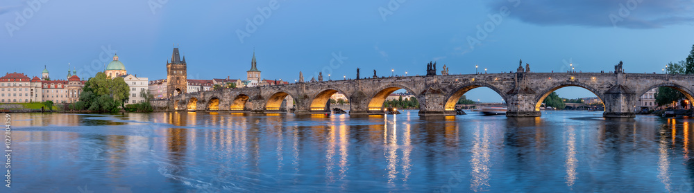Charles Bridge (Karlův most) over Vltava river, illuminated in the evening, Prague, Czech Republic