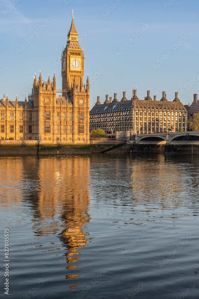 Early sunny morning with Palace of Westminster and Big Ben clock tower seen across River Thames, London, United Kingdom