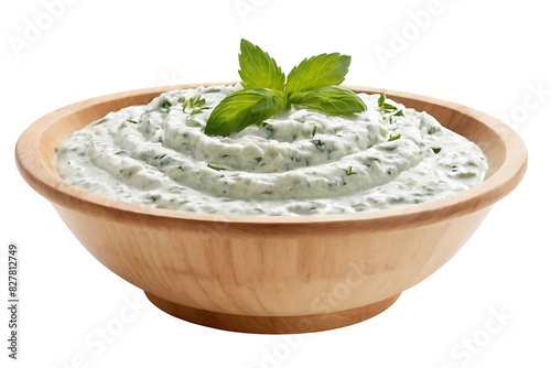 A wooden bowl filled with creamy tzatziki sauce, garnished with a sprig of fresh herbs. Perfect for food blogs, recipe websites, restaurant menus, or food product packaging