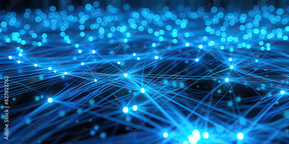 Fototapeta premium A network of glowing blue fiber optic cables connects multiple devices, forming a mesmerizing pattern.