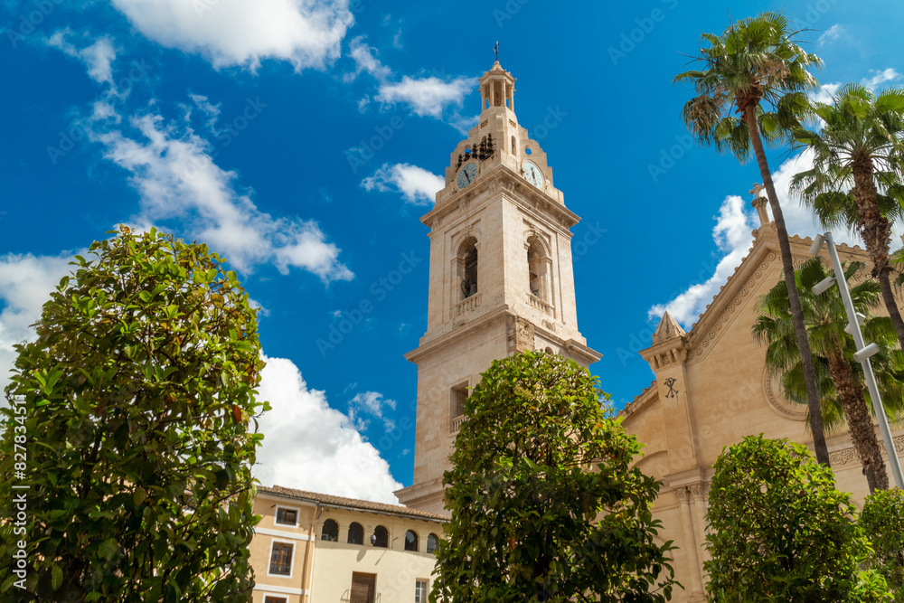 Bell tower in Xativa town, against blue cloudy sky. 