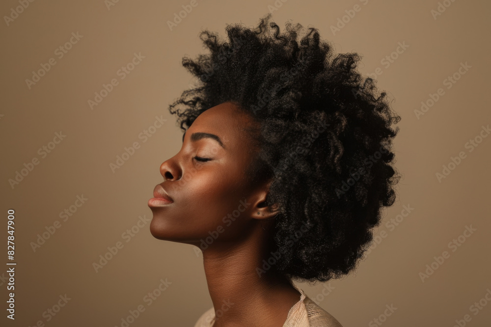 A close up of a black woman's face with her eyes closed looking to a side A close up of a black woman's face with her eyes closed looking to a side