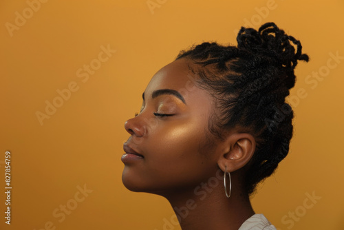 A close up of a black woman's face with her eyes closed looking to a side © MagnusCort